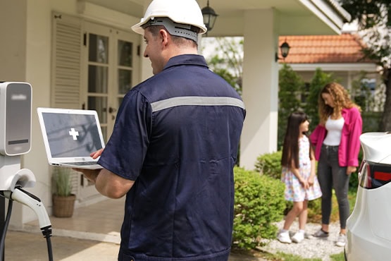 Utility worker operating an EV charging station